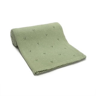 Gigi cotton knit baby blanket folded in soft sage green.