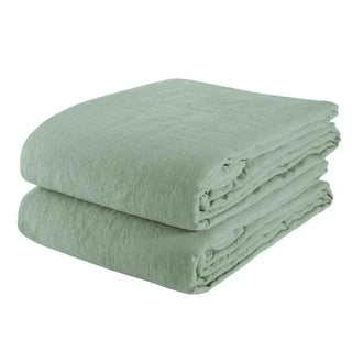 Sage green pure linen flat sheet and two standard pillowcases set. Available in a range of neutral colours and sizes from Arkaim Home. Natural linen is breathable, textured, and perfect for relaxed year-round comfort. Great for modern, Boho, Scandi, wabi-sabi bedroom interiors.