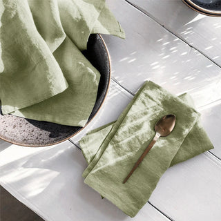Sage green linen table napkins styled for organic interiors.