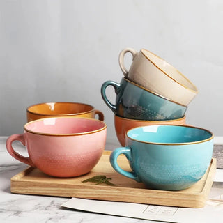 Large hand-painted ceramic mugs in beige, blue, coral and mustard yellow with dotted pattern, glossy finish, and vibrant colour, ideal for hot drinks, soup, or cereal.