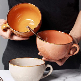 Large hand-painted ceramic mugs in beige, coral and mustard yellow with dotted pattern, glossy finish, and vibrant colour, ideal for hot drinks, soup, or cereal.