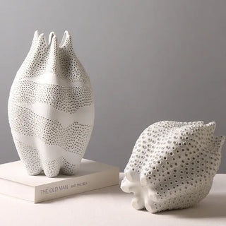 Handmade ceramic vases with sculptural coral-inspired shape, perforated surface and matte finish. Decorative centrepieces for modern or wabi-sabi interiors.