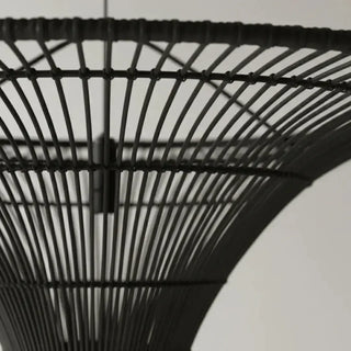 Woven black rattan ceiling pendant with organic texture.