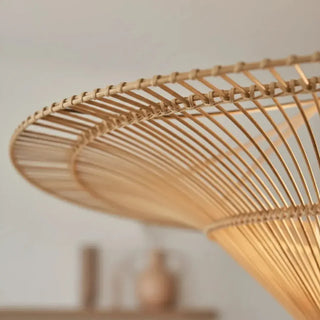 Natural rattan hanging light with soft filtered glow and artisanal detailing.