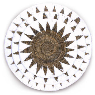 Round decorative wall plates made from seagrass and white cotton rope.