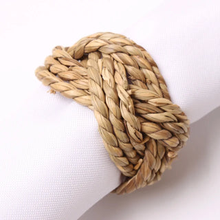 Set of six handwoven sisal napkin rings made from natural braided fibres, ideal for rustic or organic table settings.