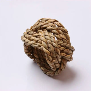 Set of six handwoven sisal napkin rings made from natural braided fibres, ideal for rustic or organic table settings.
