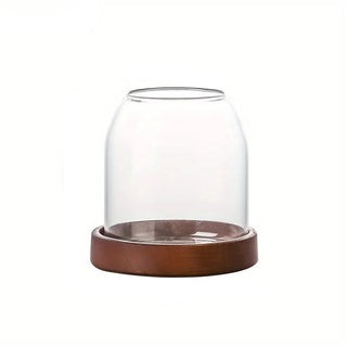 Clear glass cutlery holder with wooden base for forks, spoons and kitchen utensils.