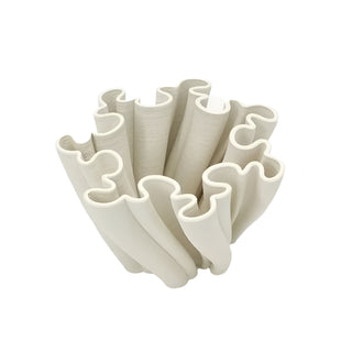 A sculptural, white decorative centerpiece bowl with an intricate, undulating design. The bowl's structure features twisted, fluted elements that create a dynamic, flowing appearance. The design is modern and minimalist, adding an artistic touch to home decor