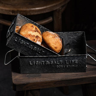 Handmade black rustic iron metal serving tray with handles, perfect for kitchen and pantry storage. This versatile bread box-style tray adds a vintage touch to homeware collections, ideal for serving, organizing, or decorative display. Crafted from natural materials for a timeless, functional aesthetic.