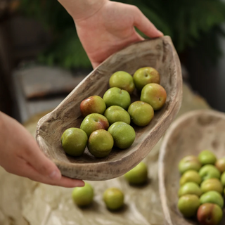Handcrafted Kodai tray made from natural Paulownia wood, featuring a rustic boat-shaped design that showcases organic beauty. This decorative and practical accessory adds texture and character to any setting, perfect for displaying fruit, trinkets, potpourri, or holiday ornaments. A unique piece for natural home décor.