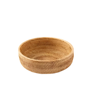 Small round handwoven natural rattan storage basket, ideal for organising or serving snacks in an eco-friendly home.