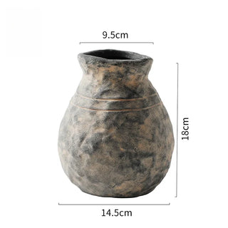 The Alma Clay Vase, made from stoneware clay, adds rustic charm with its textured finish and organic shape. Featuring uneven edges for a beautifully raw, simple design, this decorative accessory is perfect for displaying flower or branch arrangements. The Alma flower vase makes an elegant addition to shelves or consoles, enhancing natural home décor.