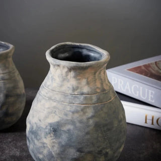 The Alma Clay Vase, made from stoneware clay, adds rustic charm with its textured finish and organic shape. Featuring uneven edges for a beautifully raw, simple design, this decorative accessory is perfect for displaying flower or branch arrangements. The Alma flower vase makes an elegant addition to shelves or consoles, enhancing natural home décor.