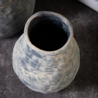 The Alma Clay Vase, made from stoneware clay, adds rustic charm with its textured finish and organic shape. Featuring uneven edges for a beautifully raw, simple design, this decorative accessory is perfect for displaying flower or branch arrangements. The Alma flower vase makes an elegant addition to shelves or consoles, enhancing natural home décor.