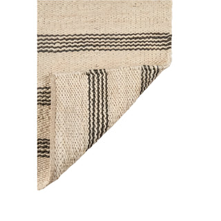 Handmade striped jute rug. featuring a simple natural and black stripe pattern. Natural flooring ideas. Natural and sustainable home rugs.