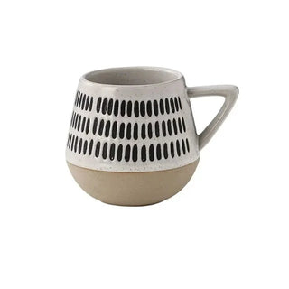 Nordic-inspired handmade clay mug with a white satin-speckled glaze and black graphic motif, perfect for tea and coffee.