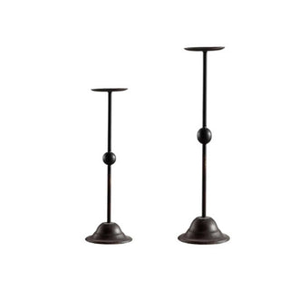 Two-size black iron candle holders fn minimalist dining setting.