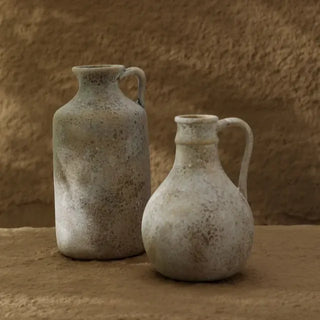 Two minimalist ceramic , jug shaped, vases with textured surface and soft organic form. Sculptural decor pieces for Japandi, wabi-sabi, or modern interiors.