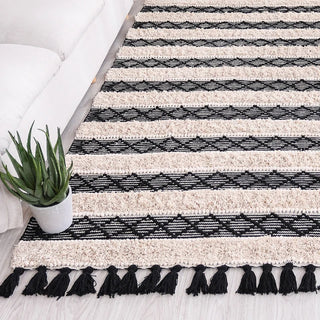 Handwoven Moroccan cotton kilim rug with tufted construction, ivory and black geometric design, and tactile fringe – perfect for Scandi, Boho, or minimalist interiors.