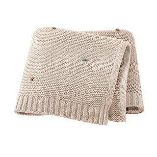 Bibi Cotton Knit Baby Blanket in soft pastel taupe, folded neatly.