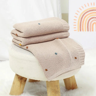 Bibi Cotton Knit Baby Blanket in soft pastel taupe, folded neatly.
