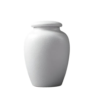Elegant white ceramic large storage jars in various shapes and sizes, featuring a soft textured finish and airtight lids. Perfect for storing tea, coffee, sugar, and spices while adding a modern, sophisticated touch to any kitchen countertop.