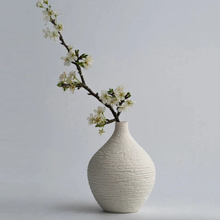 Modern ceramic flower white vases from the Emi Vases collection, featuring a sleek, minimalistic design with ribbed texture. Crafted from high-quality ceramic, these vases enhance contemporary, minimal or scandi home décor with their sculptural elegance. Perfect for displaying as a standalone piece or grouped together on a shelf or console, they add sophistication and refinement to any room.