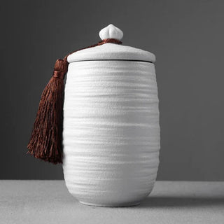 Elegant white ceramic large storage jars in various shapes and sizes, featuring a ribbed textured finish and airtight lids. Perfect for storing tea, coffee, sugar, and spices while adding a modern, sophisticated touch to any kitchen countertop.