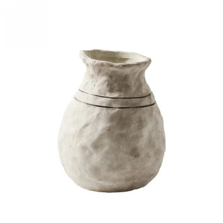 The Alma Clay Vase, made from pale stoneware clay, adds rustic charm with its textured finish and organic shape. Featuring uneven edges for a beautifully raw, simple design, this decorative accessory is perfect for displaying flower or branch arrangements. The Alma flower vase makes an elegant addition to shelves or consoles, enhancing natural home décor.
