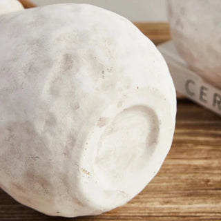 The Alma Clay Vase, made from pale stoneware clay, adds rustic charm with its textured finish and organic shape. Featuring uneven edges for a beautifully raw, simple design, this decorative accessory is perfect for displaying flower or branch arrangements. The Alma flower vase makes an elegant addition to shelves or consoles, enhancing natural home décor.