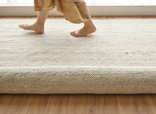 Anvi handmade wool and linen rug in beige earthy tones, featuring a bubbly textured surface - ideal for Scandi, minimalist, or modern interiors.