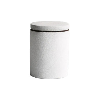 White ceramic kitchen storage canister with lid, minimalist design.