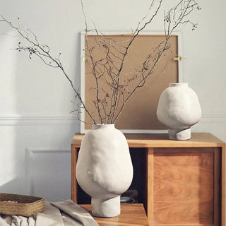 White ceramic sculptural vases with a minimalist design, available in two sizes that can be styled together. These vases features a creative, artistic shape and a sleek black finish, perfect for adding a bold, statement look to any modern or contemporary interior.