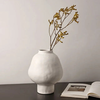 White ceramic sculptural vase with a minimalist design, available in two sizes that can be styled together. The vase features a creative, artistic shape and a sleek black finish, perfect for adding a bold, statement look to any modern or contemporary interior.