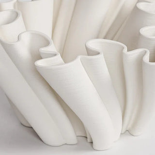 Sculptural ceramic object with coral-like fluted detailing.