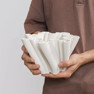White ceramic decorative vase for minimalist interiors.