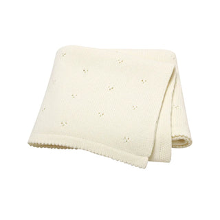 Gigi cotton knit baby blanket folded in soft white.