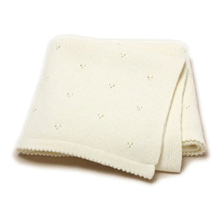 Gigi cotton knit baby blanket folded in soft white.