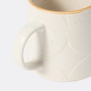Close-up of embossed white ceramic mug Arkaim Home
