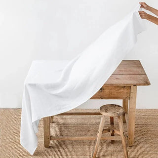 White linen tablecloth with soft natural drape.