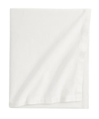 White cotton tablecloth with soft texture and elegant drape for modern, minimalist dining setting.