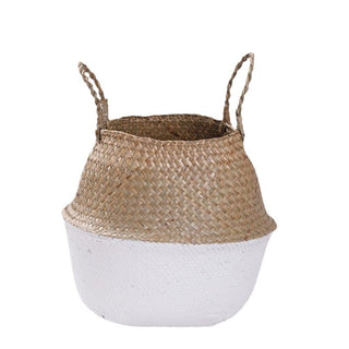 Handwoven seagrass storage basket with white painted bottom.