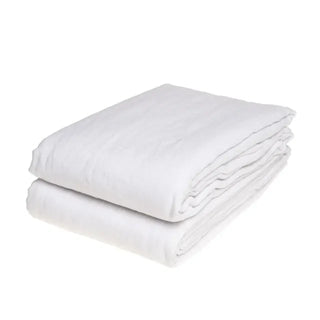 White pure linen flat sheet and two standard pillowcases set. Available in a range of neutral colours and sizes from Arkaim Home. Natural linen is breathable, textured, and perfect for relaxed year-round comfort. Great for modern, Boho, Scandi, wabi-sabi bedroom interiors.