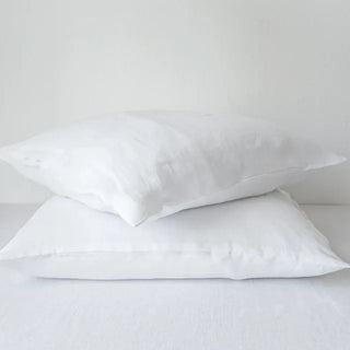 White pure linen flat sheet and two standard pillowcases set. Available in a range of neutral colours and sizes from Arkaim Home. Natural linen is breathable, textured, and perfect for relaxed year-round comfort. Great for modern, Boho, Scandi, wabi-sabi bedroom interiors.