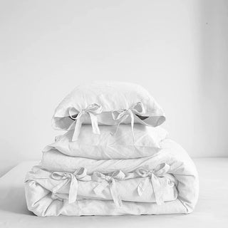 Pure stone washed 3 pcs linen bedding set with ribbon tie closure in white – available in multiple colours and sizes from Arkaim Home. Perfect for a modern, Boho, Nordic or coastal bedroom styling.  