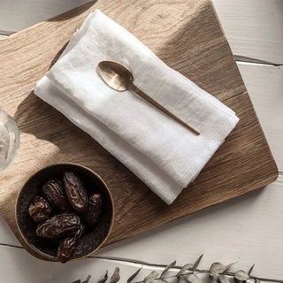 Set of 2 white linen table napkins styled on table for rustic, minimalist look.