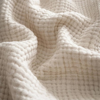 Close-up of six-layer gauze texture with soft fringe edges.