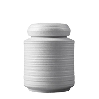 White ribbed ceramic storage jar with lid for kitchen storage.
