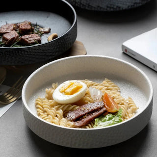 Embossed ceramic deep plates in white, and black from the Suki collection by Arkaim Home. Ideal for ramen, pasta, salad and fruits.